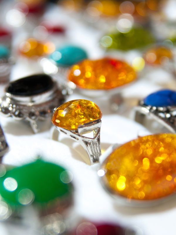 Assorted one-of-a-kind Antique rings with sapphires, emeralds, and rubies displayed on a velvet ring tray