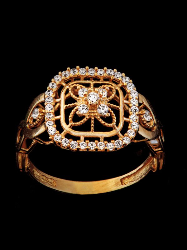 Victorian gold ring with rose-cut diamond resting on an old handwritten letter and antique 